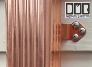 Here is a close-up of a hidden hanger and screw, in an almond painted aluminum gutter 